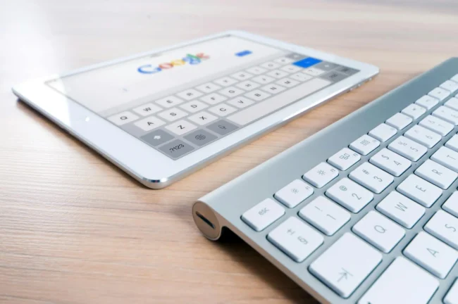 Tablet with Google search and white keyboard.