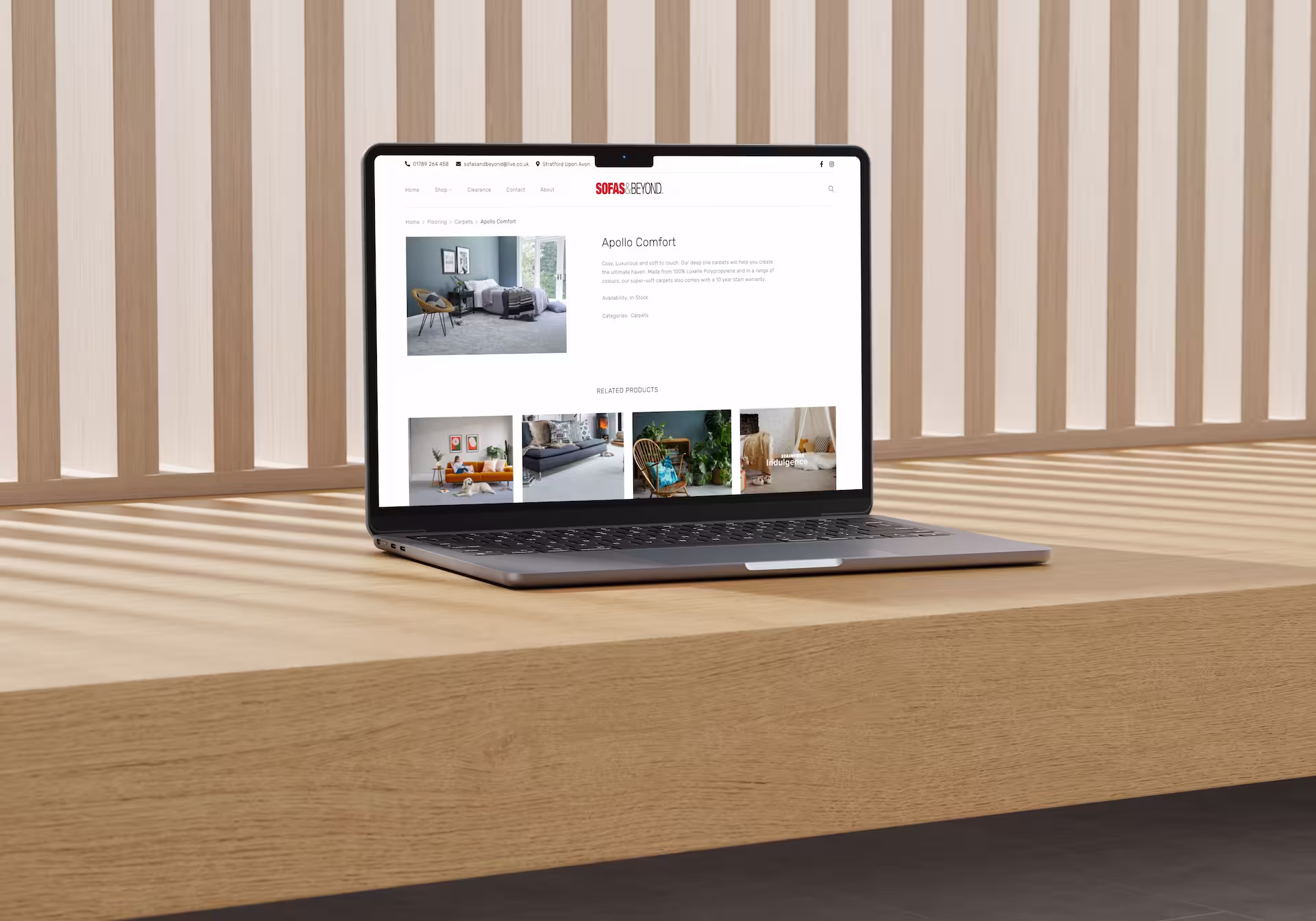 A laptop computer on a wooden shelf shwoing a website.
